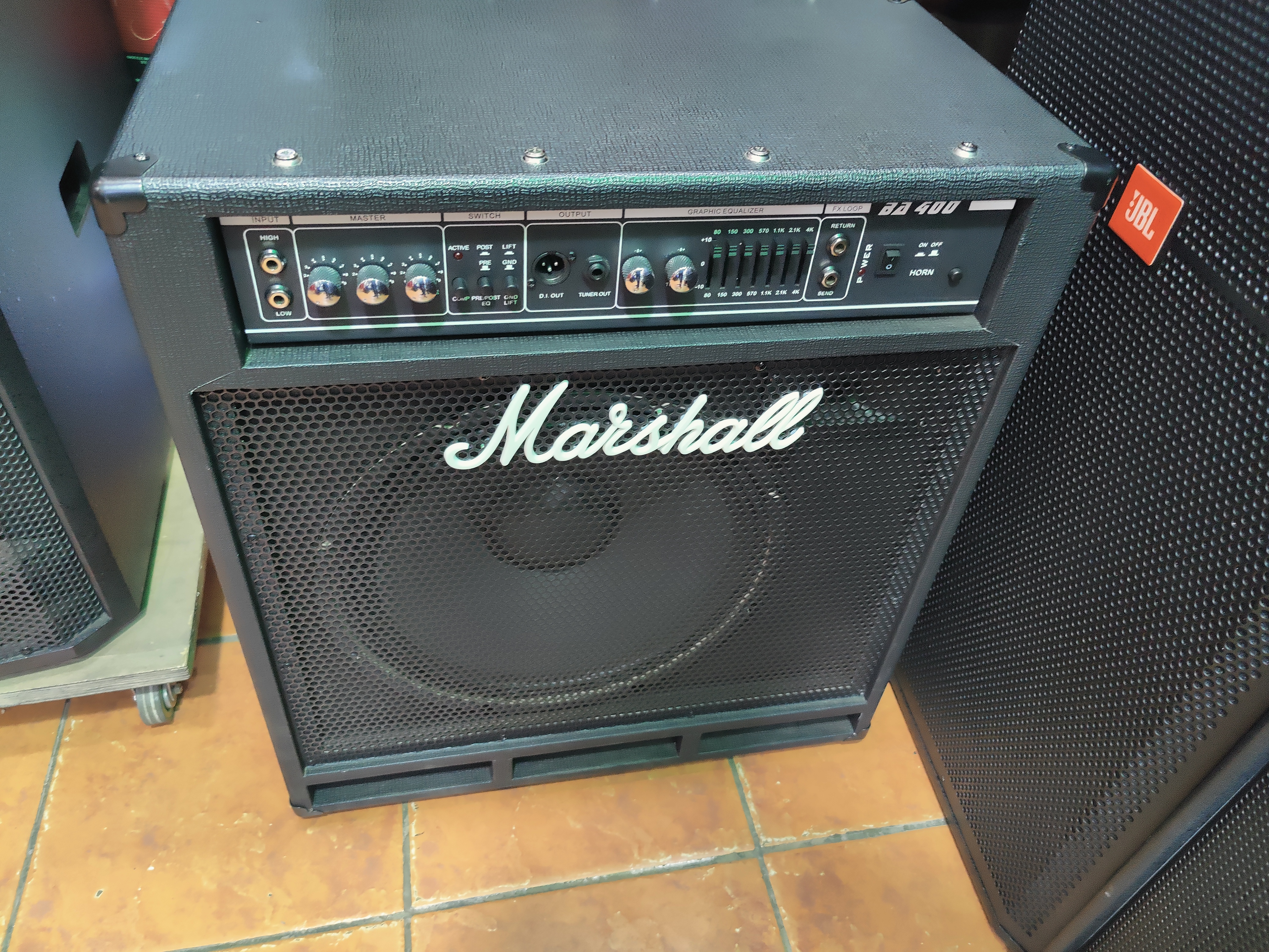 Marshall BA400 professional bass amplifier with graphic EQ, XLR DI output, effects loop, tuner output, switchable horn, and high-power speaker for live performance and studio use.